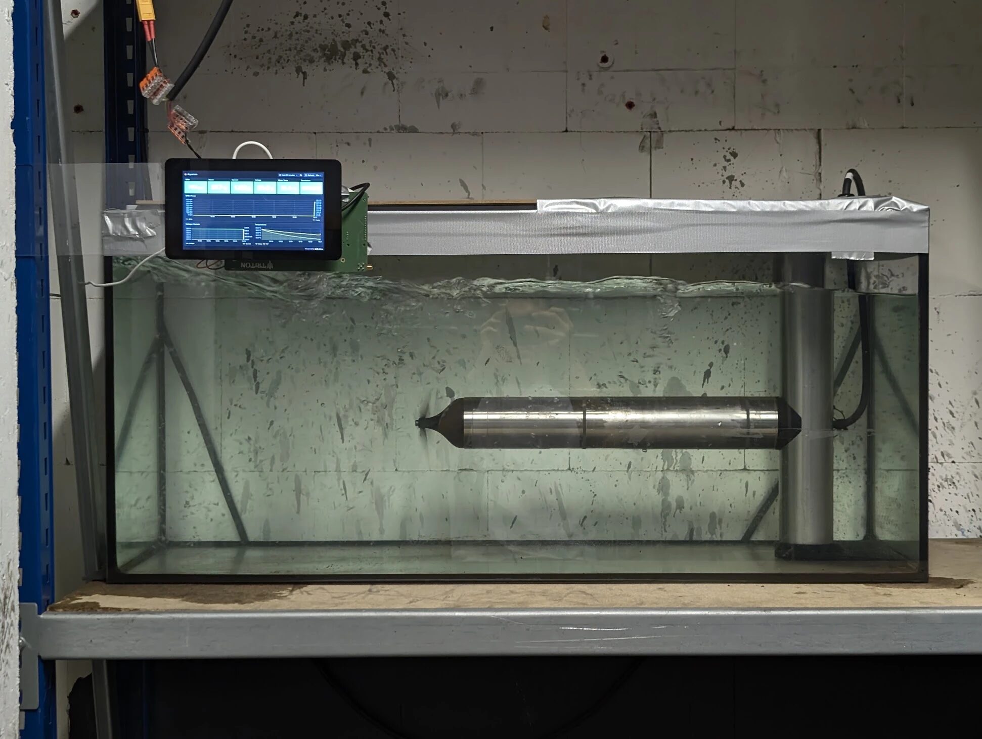 The completed thruster running in the aquarium test bench